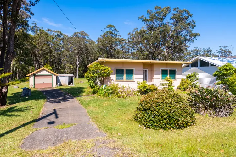 Before: a small flat-roofed fibro cottage with a separate garage on the Huskisson block